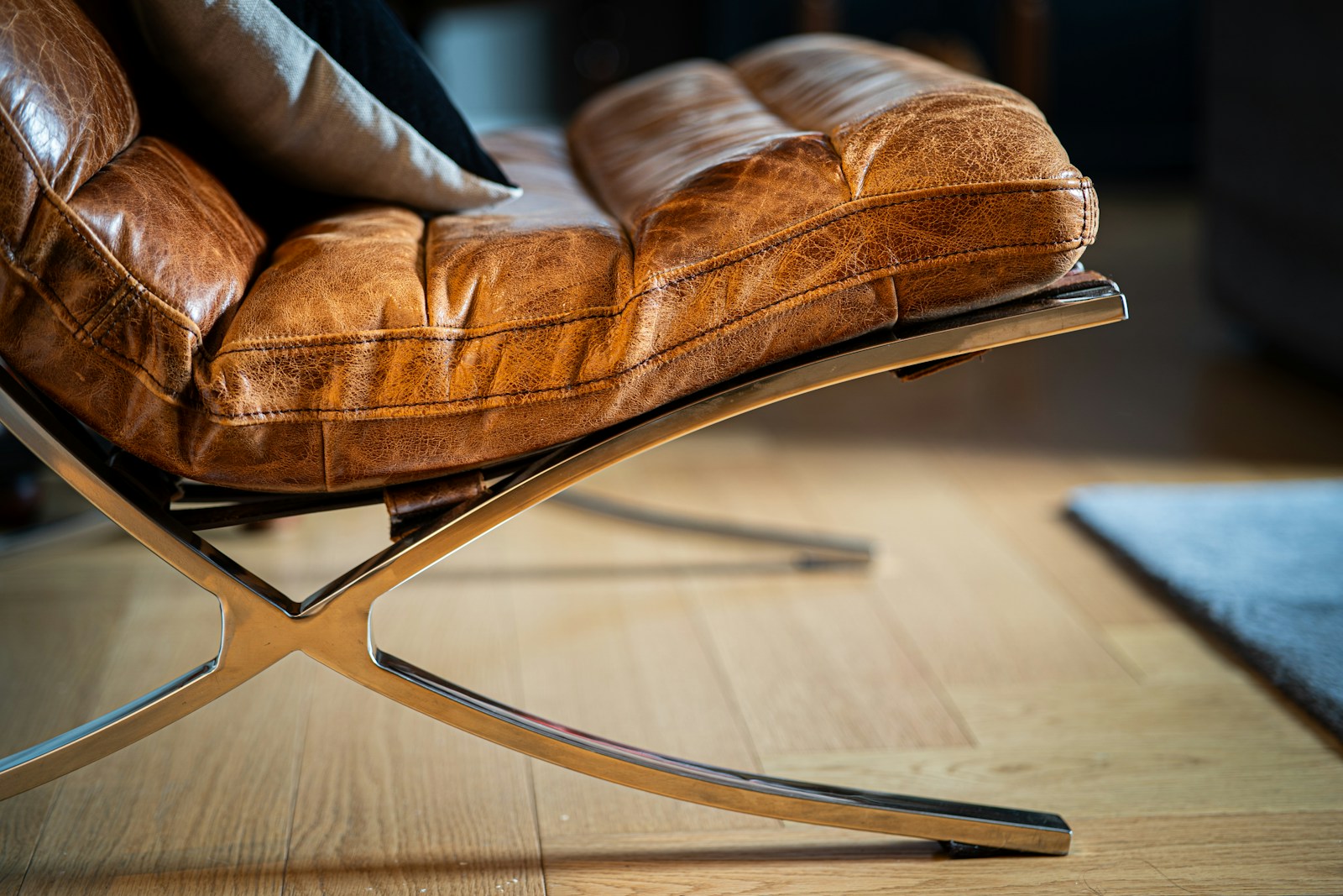 A brown leather chair sitting on top of a wooden floor